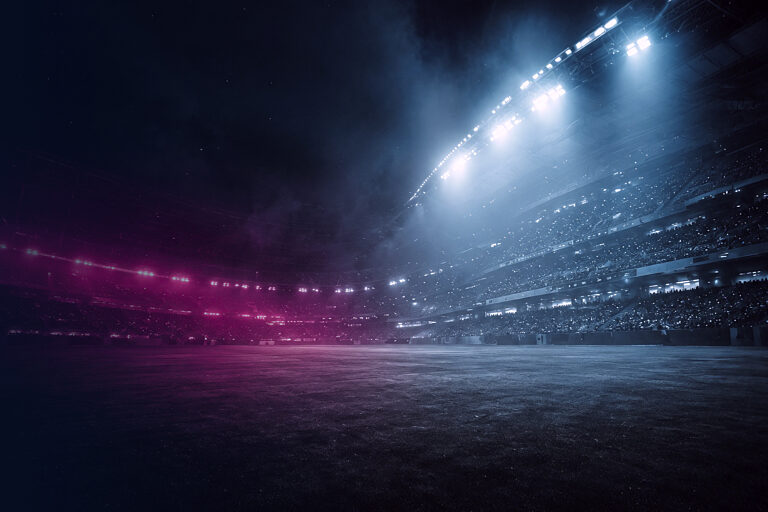 Stadion bei Nacht mit Flutlicht und magentafarbenem Rauch